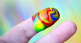 Canva-Person-Showing-Multi-coloured-Paint-On-His-Index-Finger-980x408 2